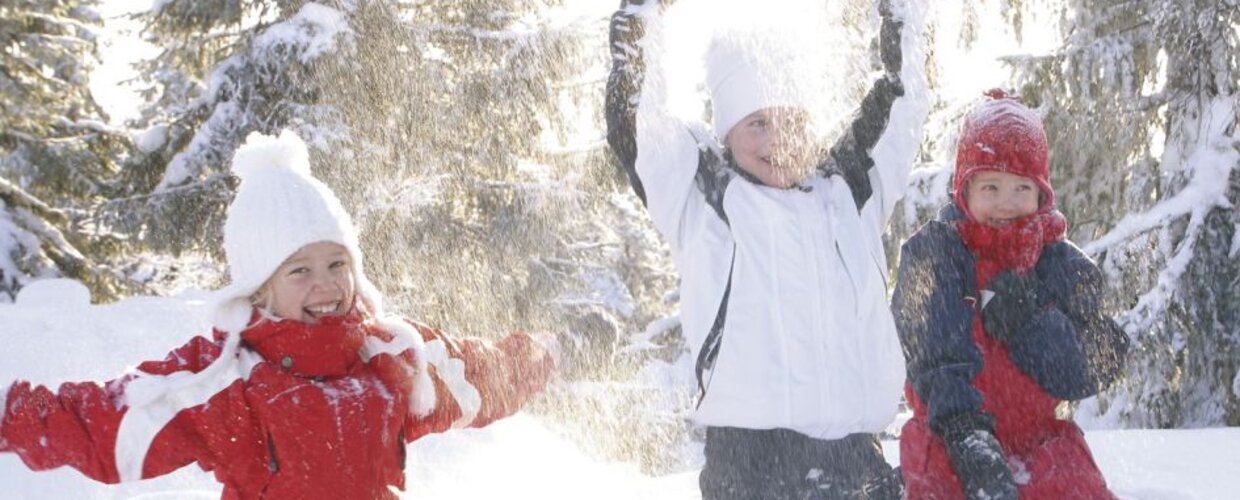 Three children playing in the snow