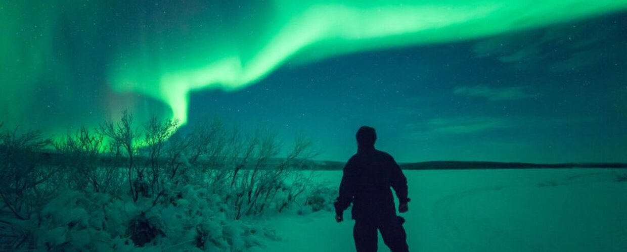 A man admiring the Northern Lights
