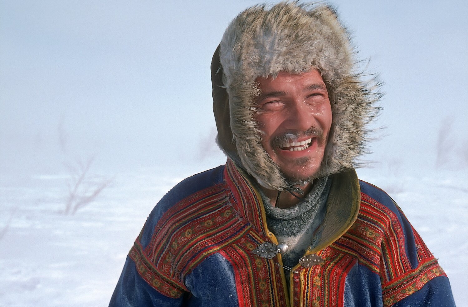 A Sami reindeer herder in the snow