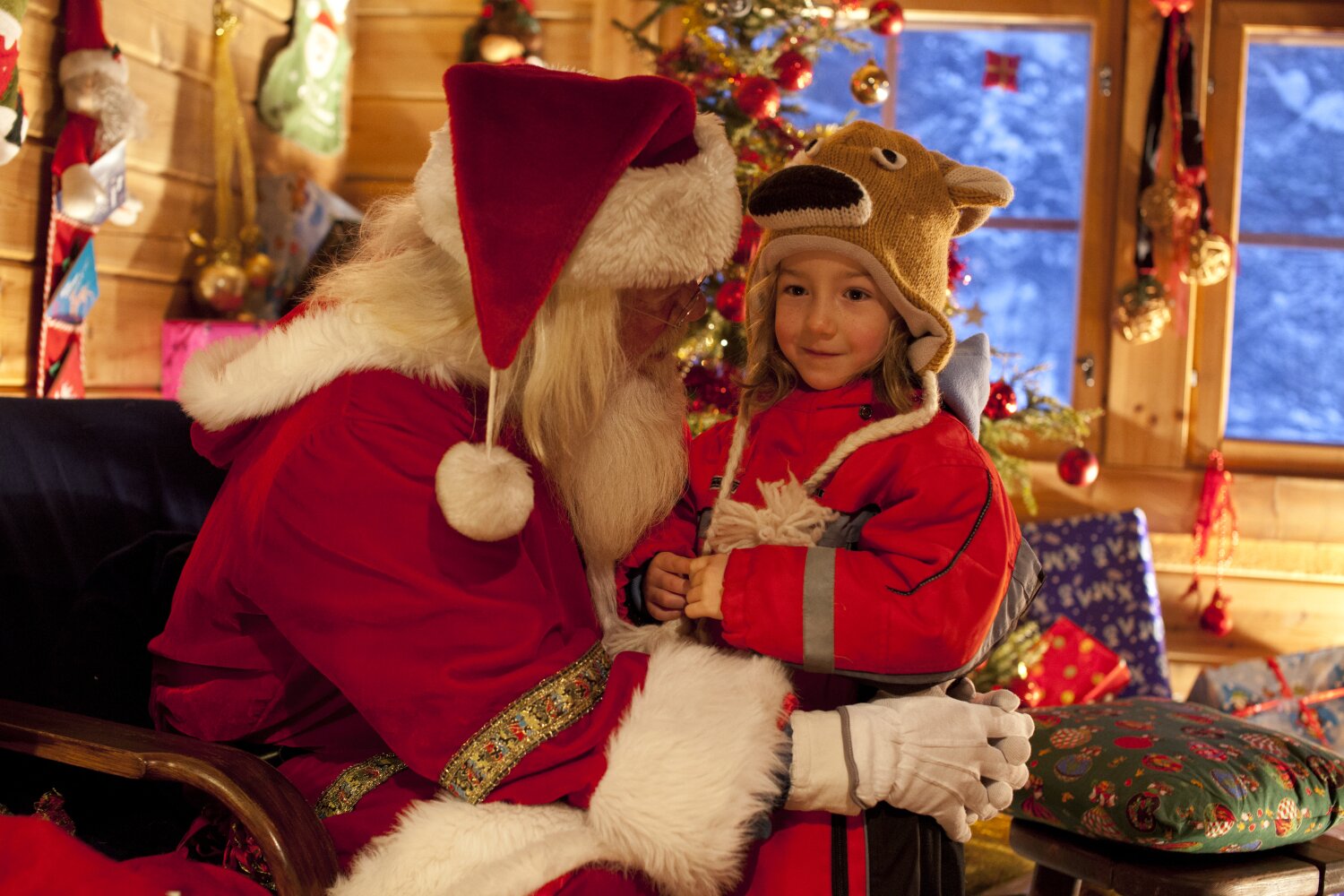 A girl shares her Christmas wishes with Santa