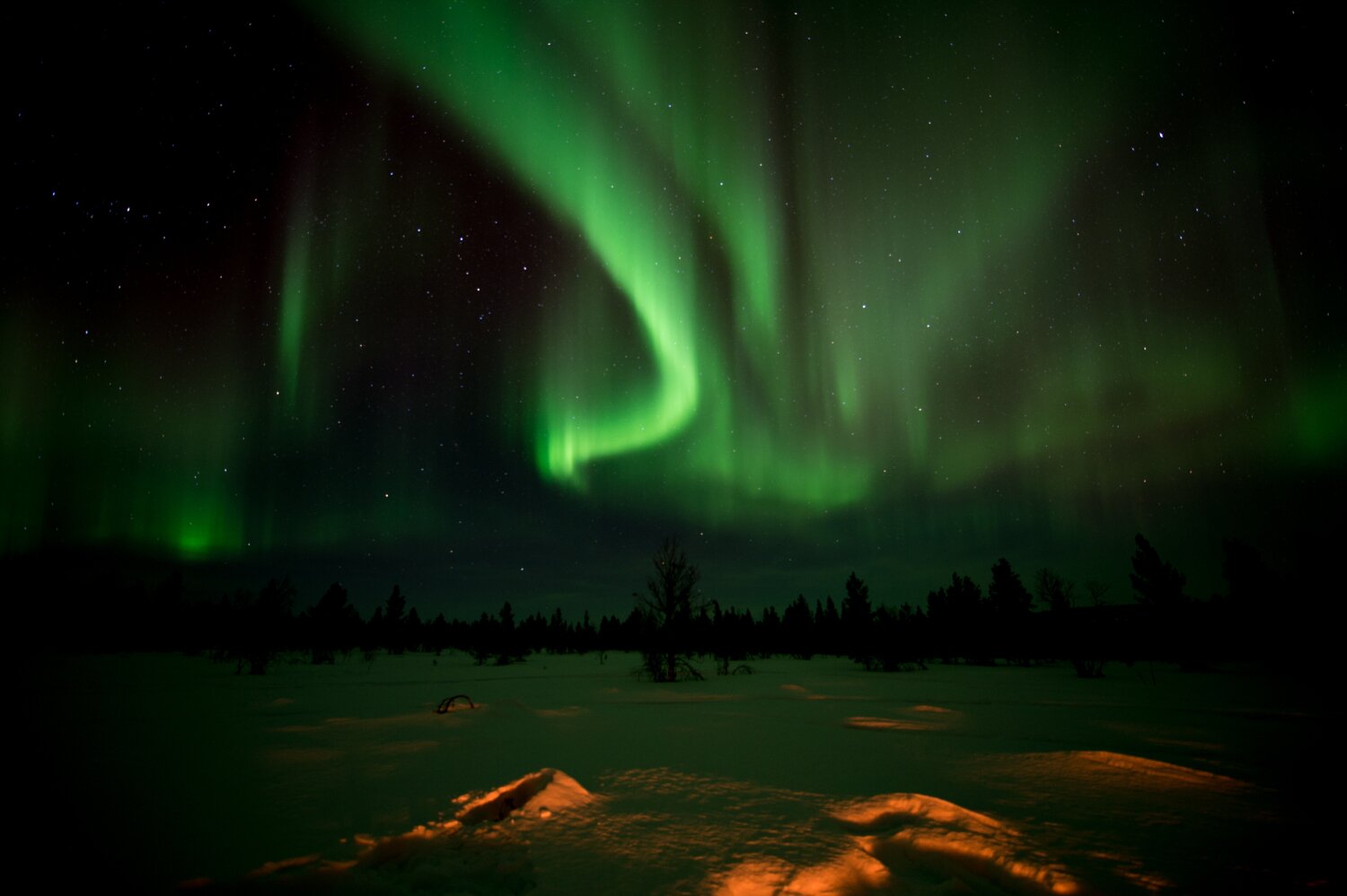 The Northern Lights over a snowy landscape