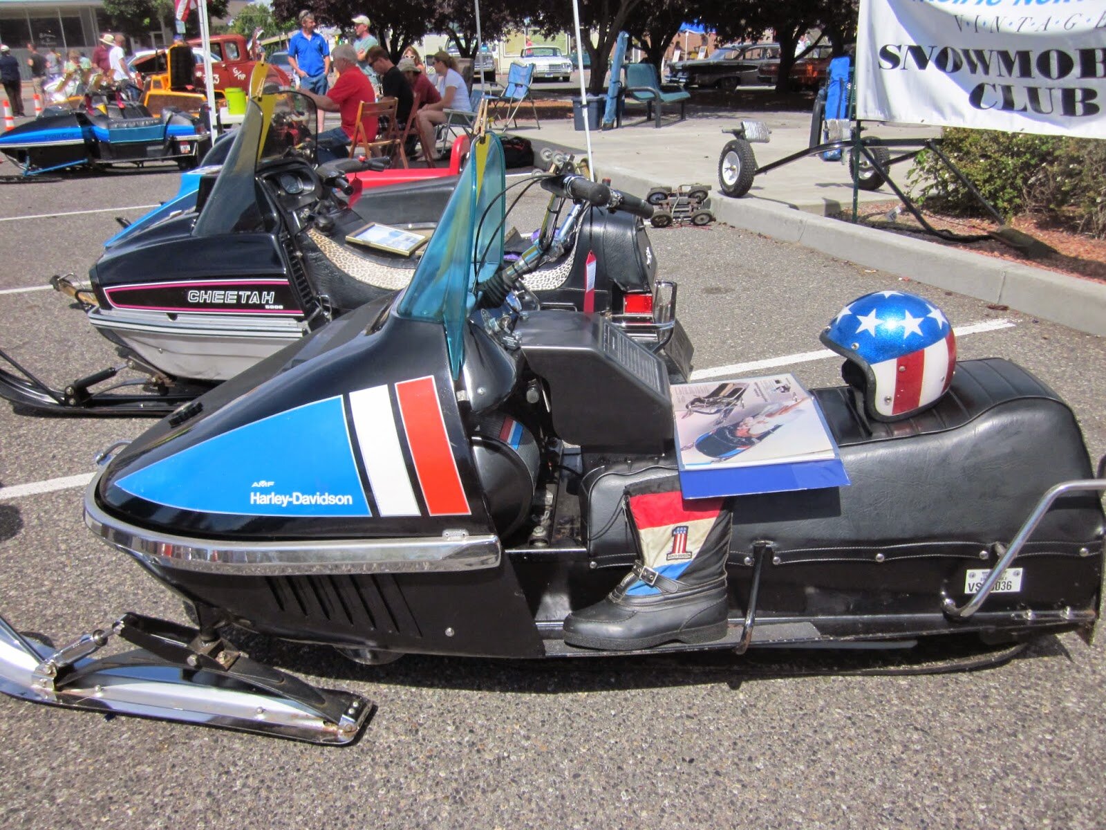 A historic Harley-Davidson snowmobile on display at a show