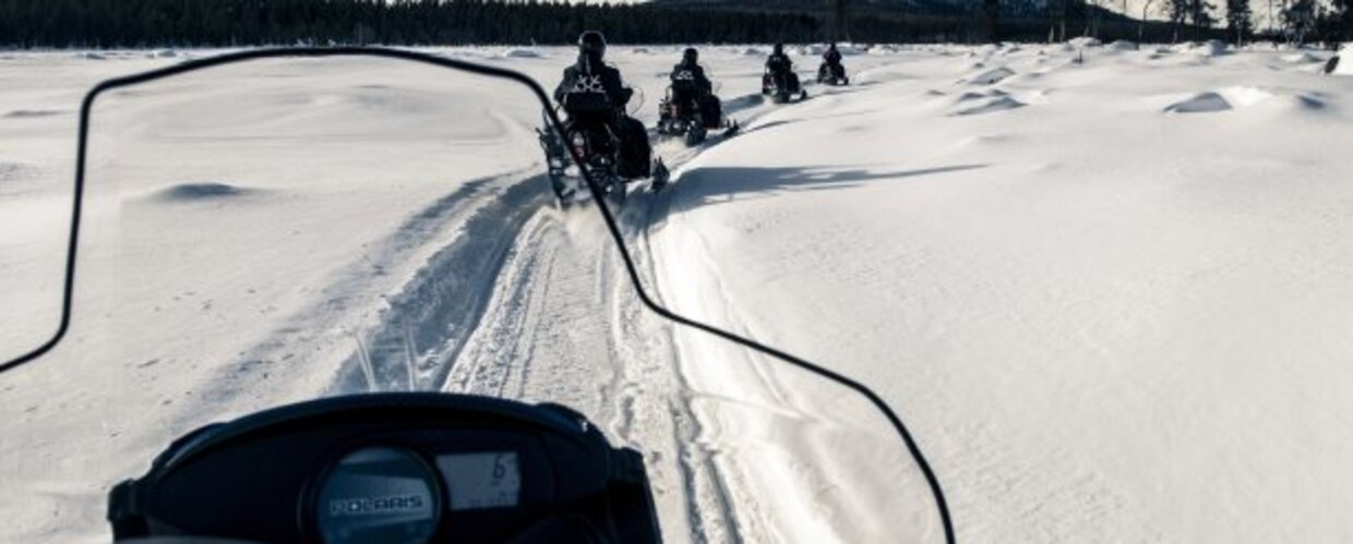 A line of snowmobiles in Kilpisjarvi, Finland