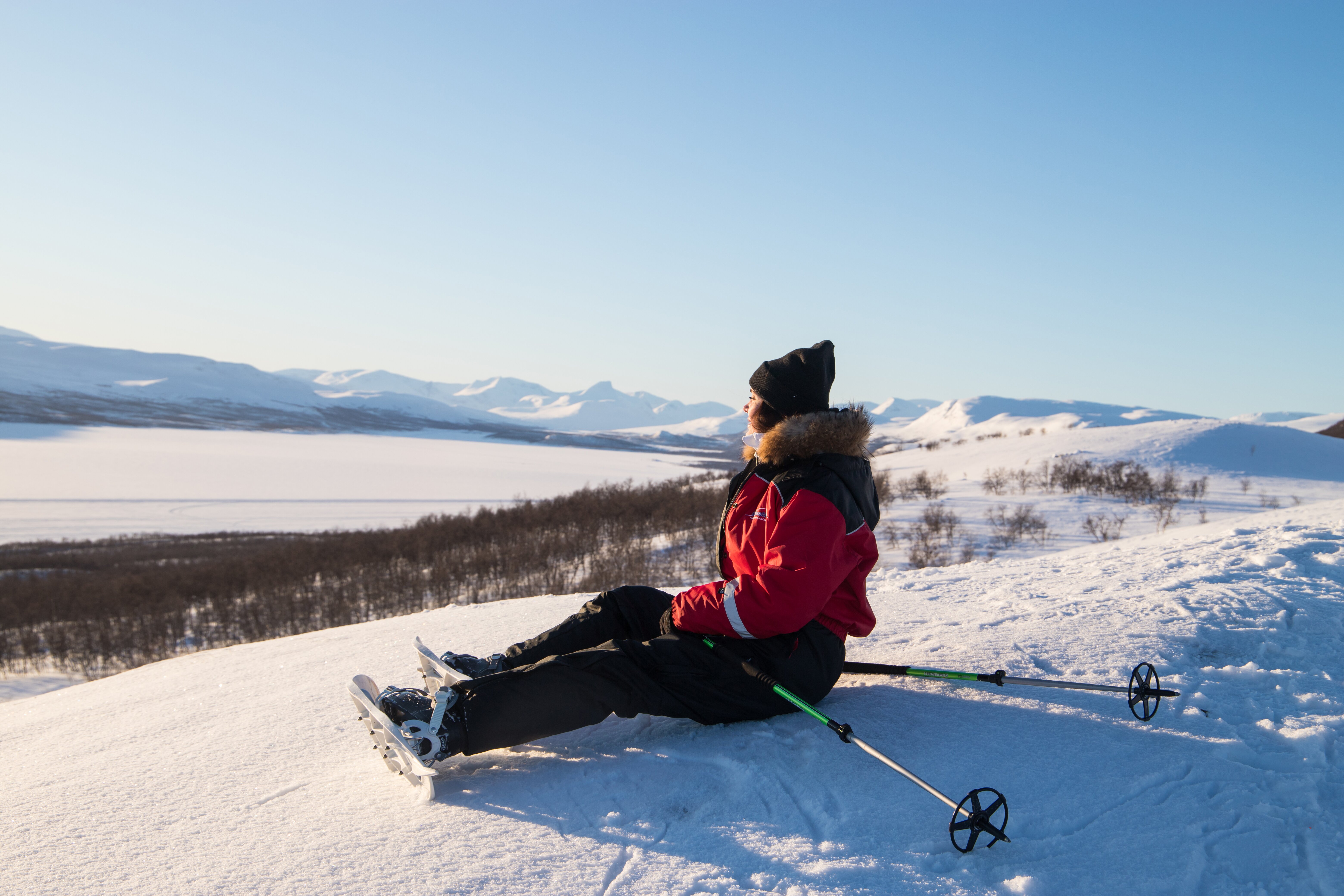 Woman snowshoeing and admiring the view