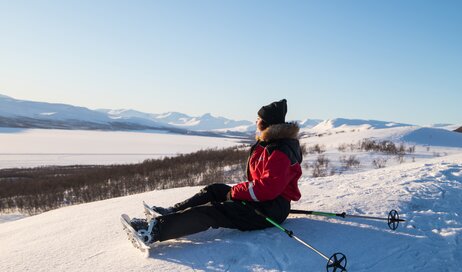 Woman snowshoeing and admiring the view