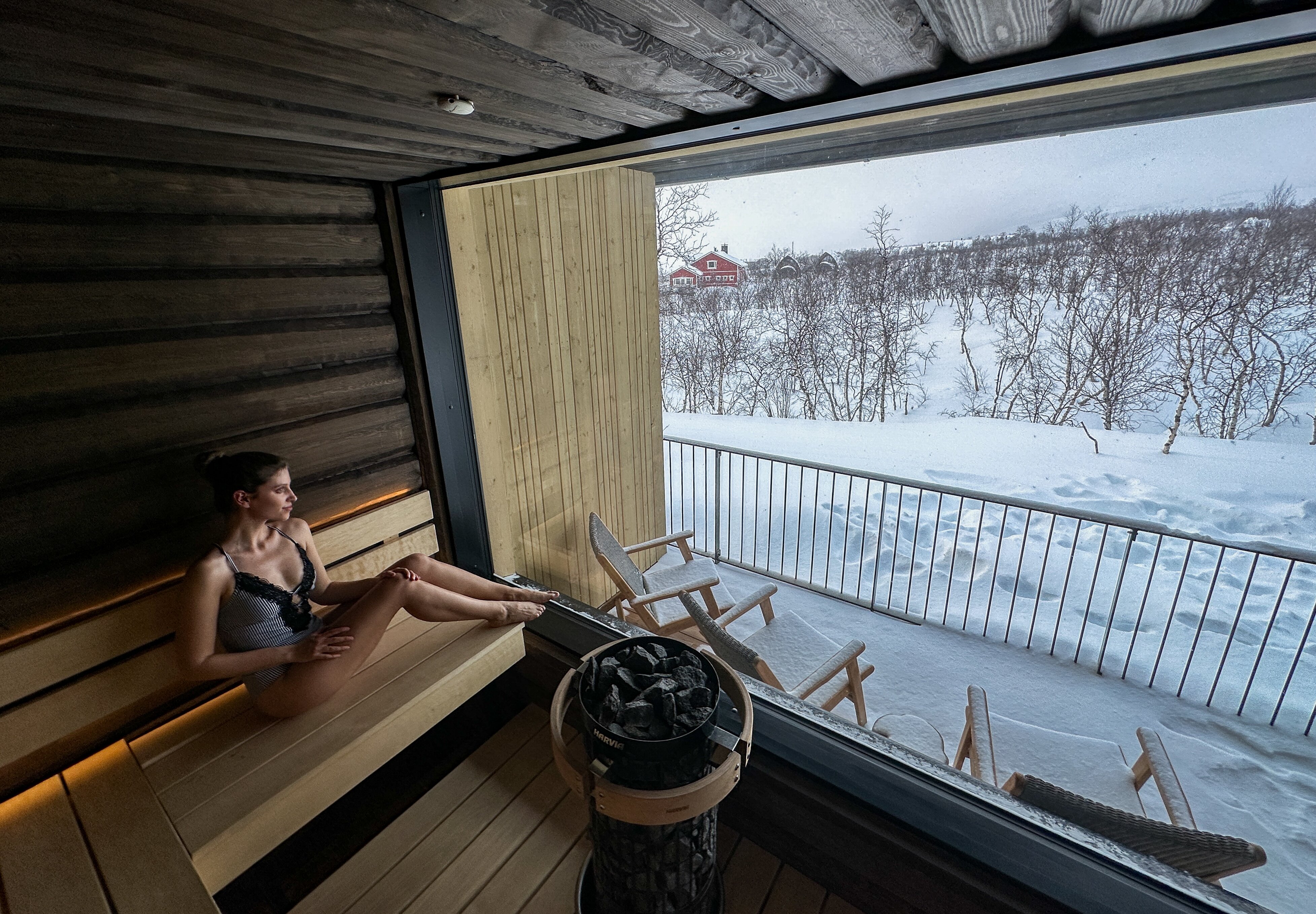 A woman enjoy the view from the sauna at Cahkal Hotel with its floor-to-ceiling windows