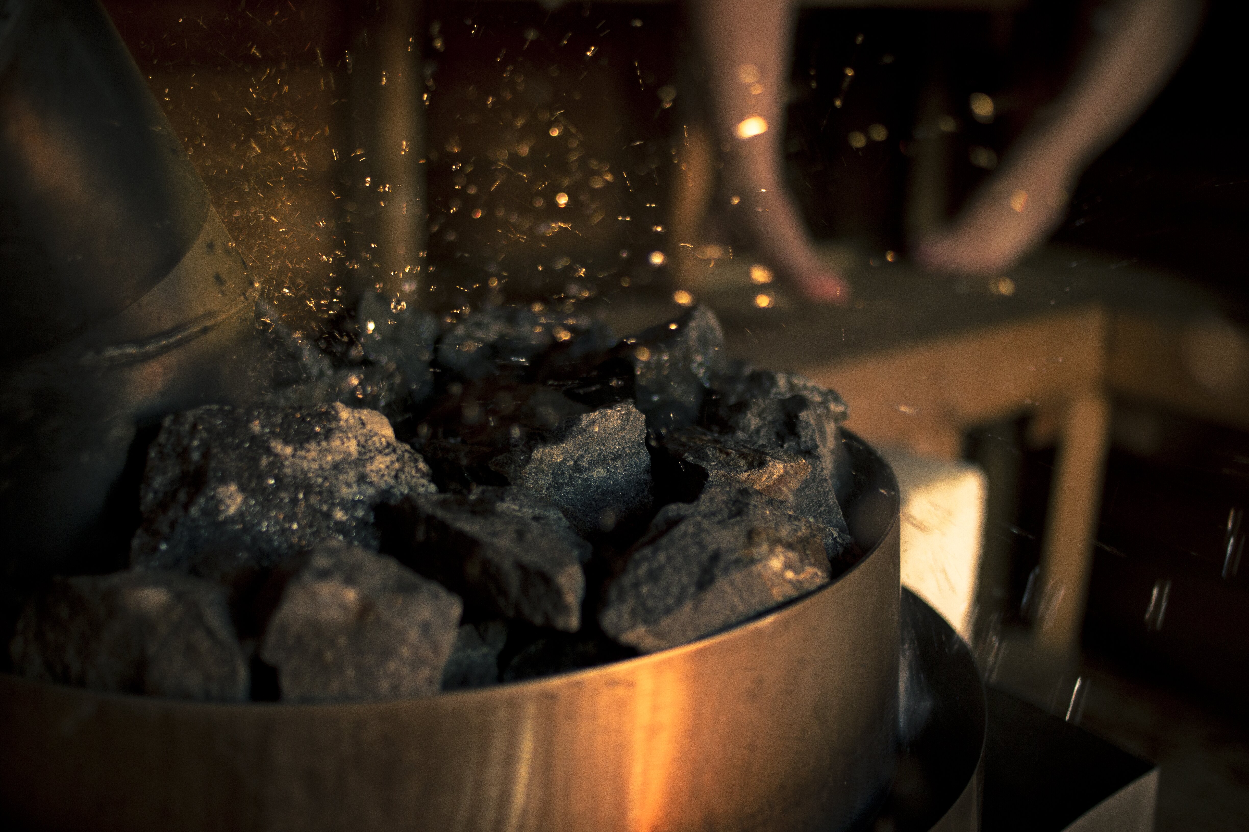 The sizzling sound of water hitting rocks in a Finnish sauna