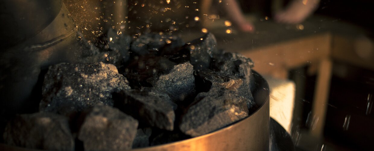 The sizzling sound of water hitting rocks in a Finnish sauna