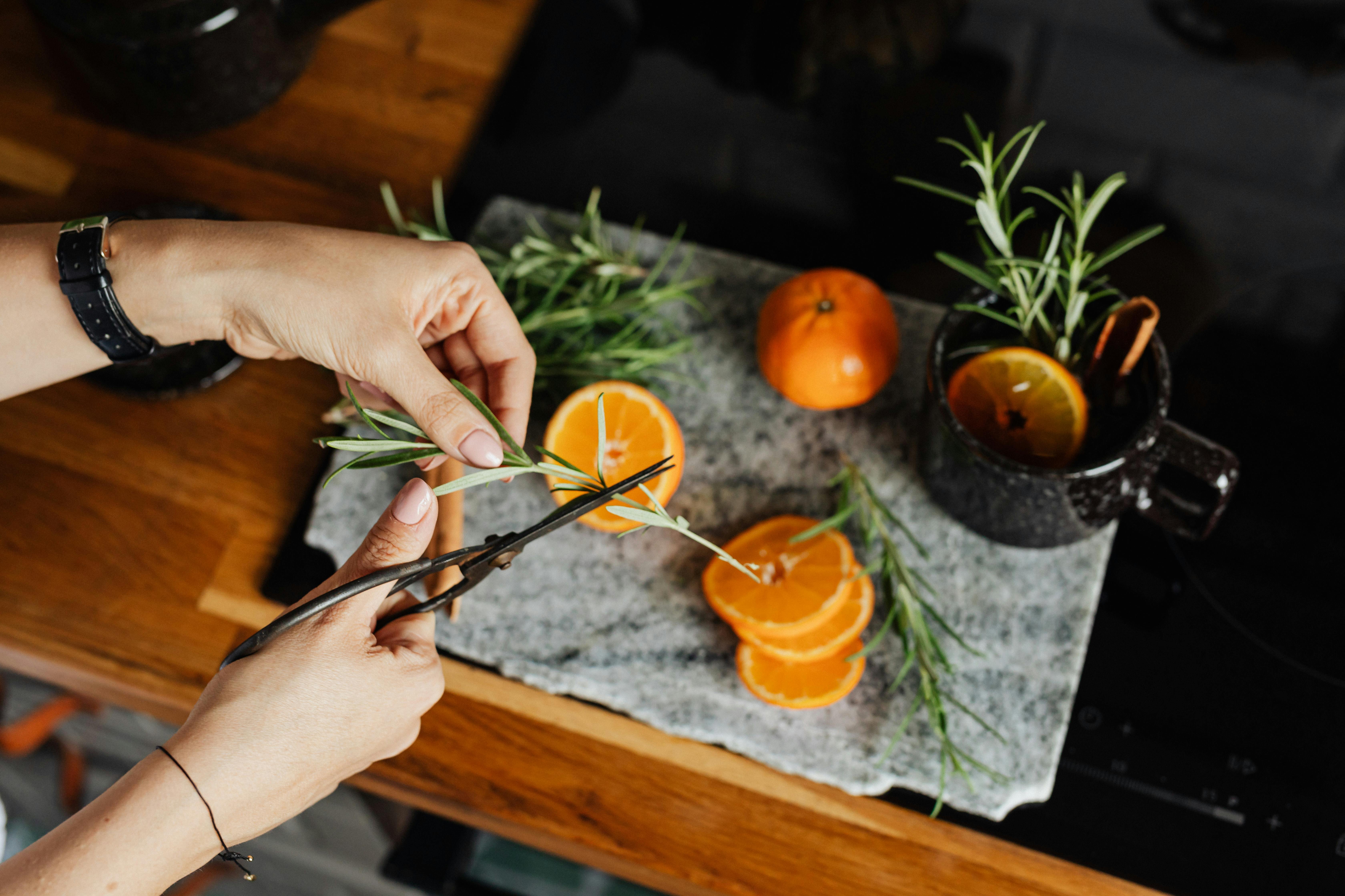 A steaming mug of glogi being made with orange slices and other garnishes