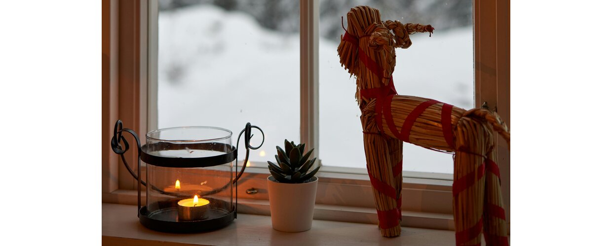 A traditional Yule Goat made from straw and placed in a window at Christmastime