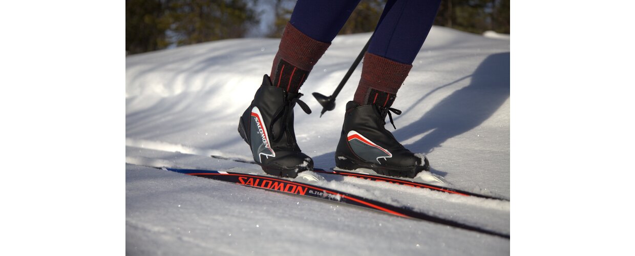 A cross-country skier exploring the fresh snow and unspoilt wide-open landscapes of Lapland